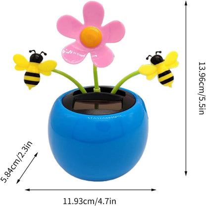 Solar powered dancing flower and bumblebees toy moving on a sunny windowsill