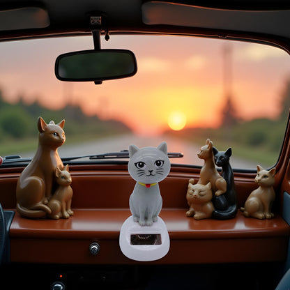 Automotive interior decoration featuring an automatic bobble head cat toy on a dashboard
