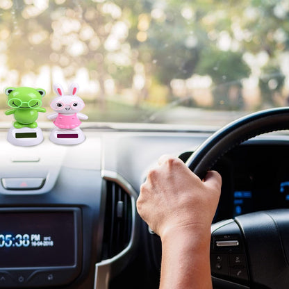 Welecom solar powered bobbleheads installed securely on a car dashboard interior.