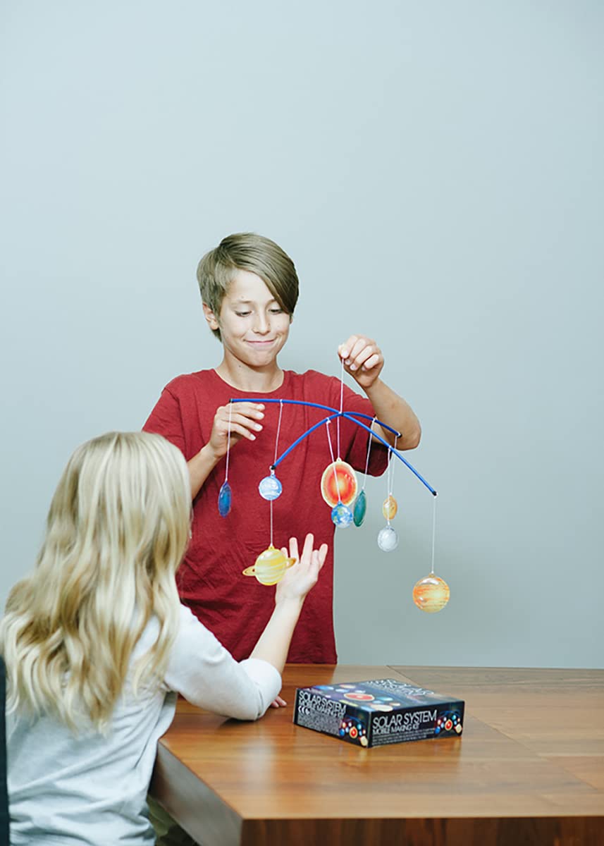Close-up view of the detailed plastic planet halves being painted with the included brush