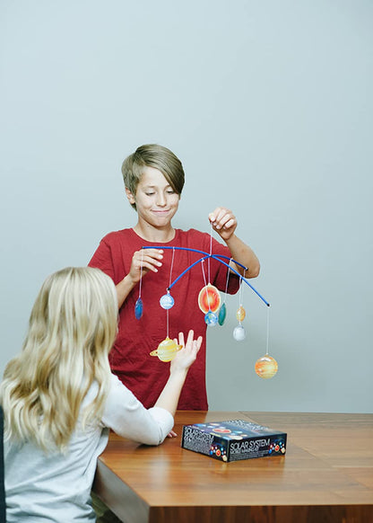 Close-up view of the detailed plastic planet halves being painted with the included brush