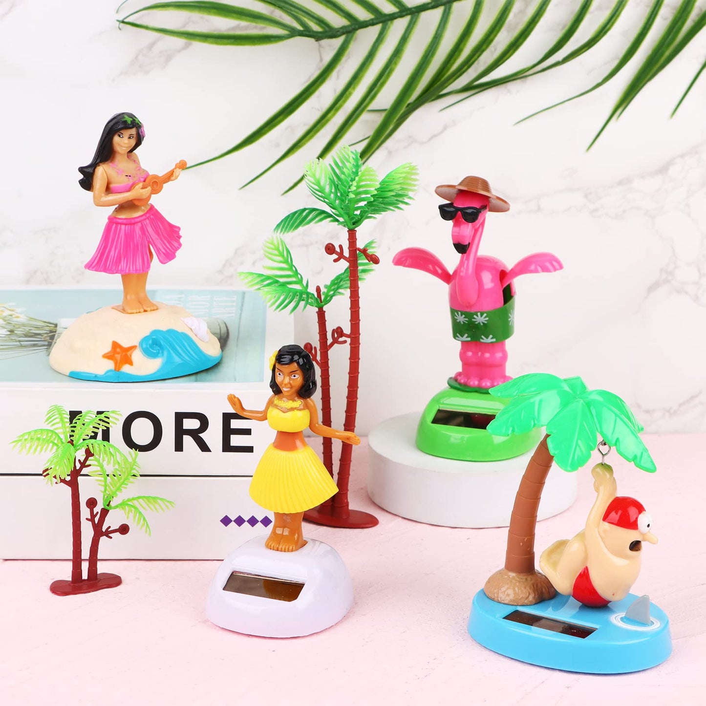 Cenryusa solar powered shaking head dancer doll swaying on an office desk next to a laptop