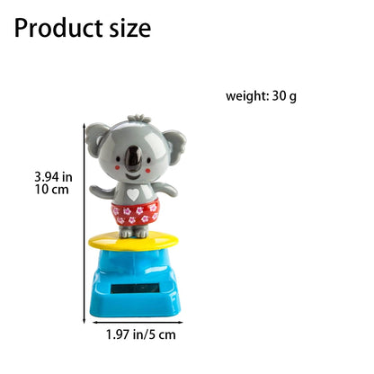 Grey cute swinging koala car dashboard ornament under bright natural lighting