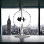 Side profile of the transparent DORAMI Crookes radiometer demonstrating thermodynamic kinetic movement.