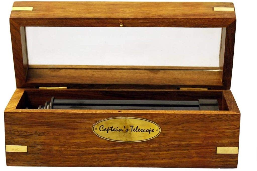 Thor Instruments fifteen inch solid brass pirate spyglass resting next to its open hand polished wooden display box