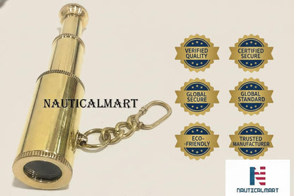 Premium handcrafted NauticalMart solid brass marine spyglass pocket key ring displayed flat on a wood surface.