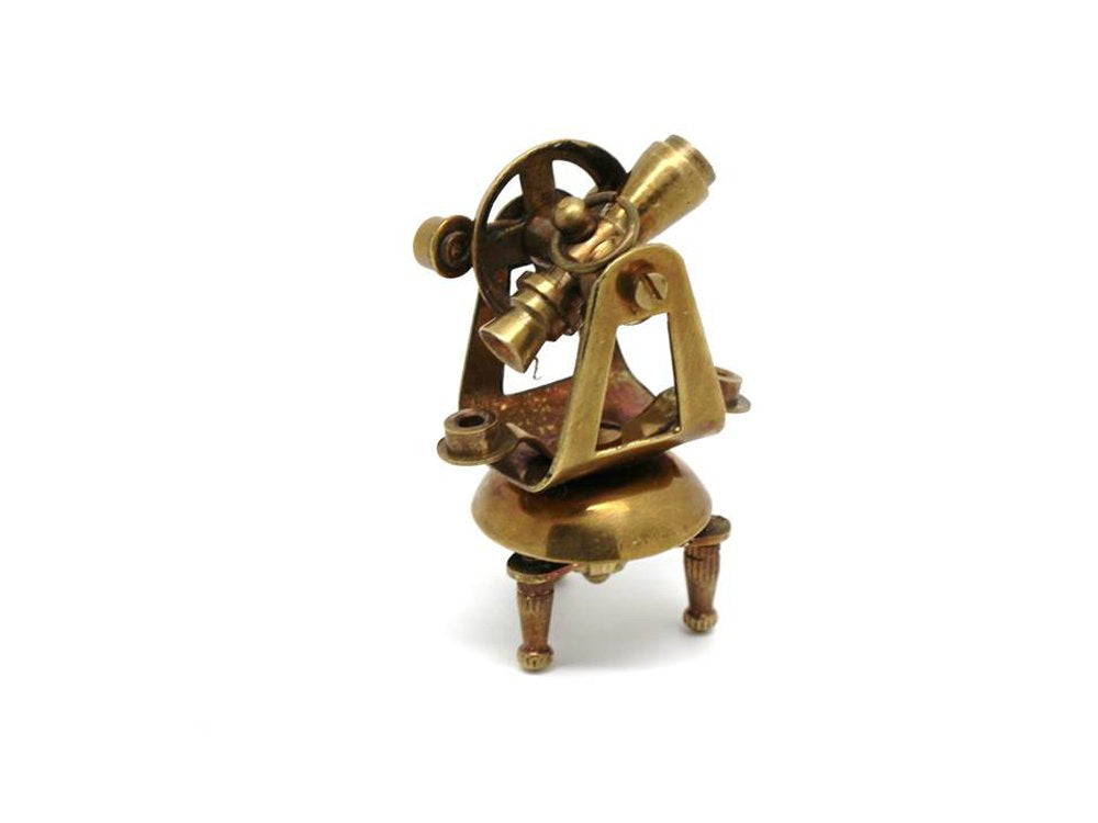 Detailed close up of miniature brass sextant and ship telegraph from the vintage collectible set