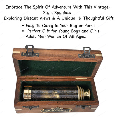 Ocean Replicas fourteen inch engraved brass spyglass telescope resting next to its open wooden storage box