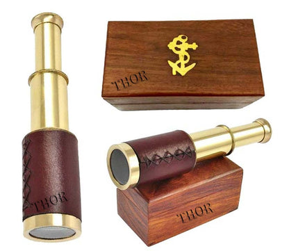 Thor Instruments vintage six inch spyglass monocular placed next to its open rustic anchor wooden storage box