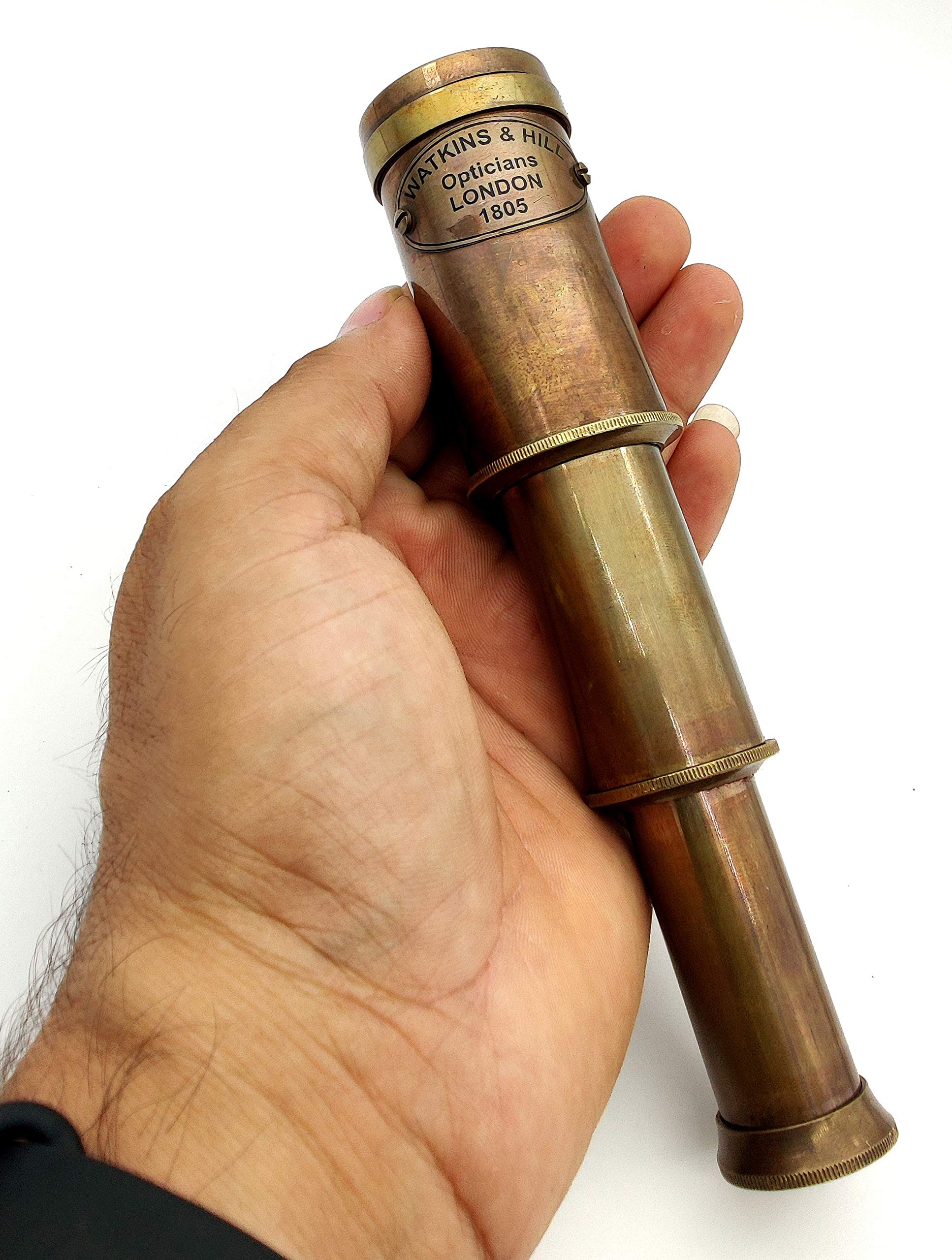 Decorative antique nautical instrument displayed on a wooden desk