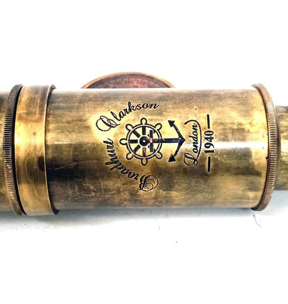 Vintage maritime collectible telescope resting on a rustic wooden surface