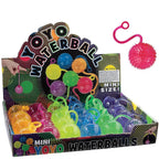 Close up of squishy neon water ball with elastic string