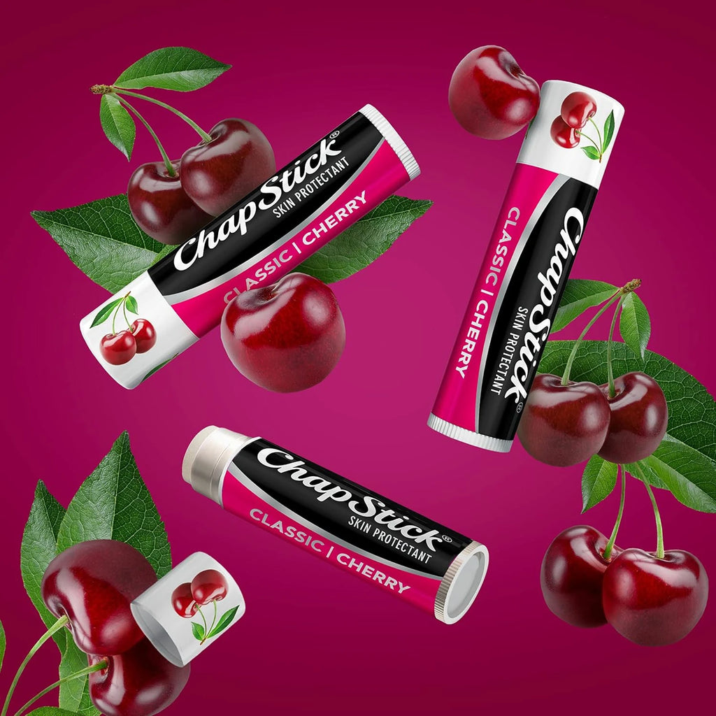 ChapStick Classic Cherry lip balm with cherries and leaves on a pink background