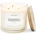 Calyan Wax Co. Evergreen and Eucalyptus 3 Wick Soy Candle front view on a wooden table.