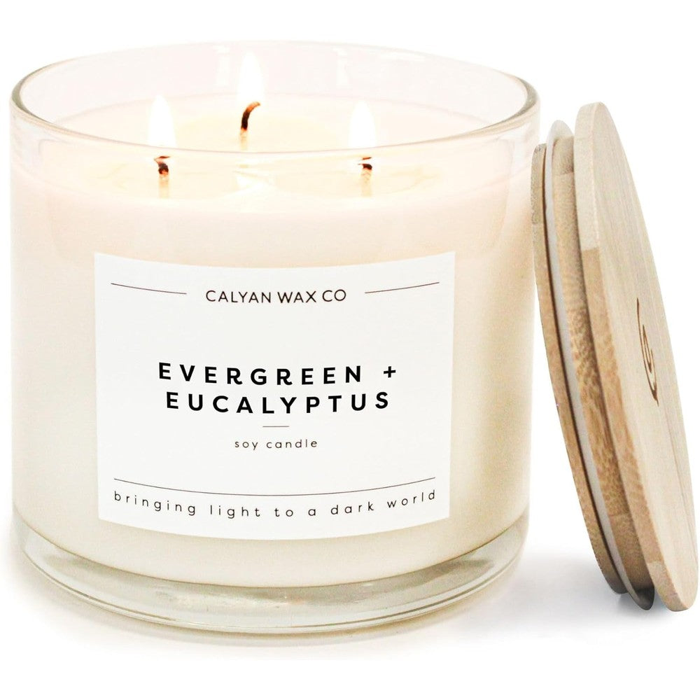 Calyan Wax Co. Evergreen and Eucalyptus 3 Wick Soy Candle front view on a wooden table.