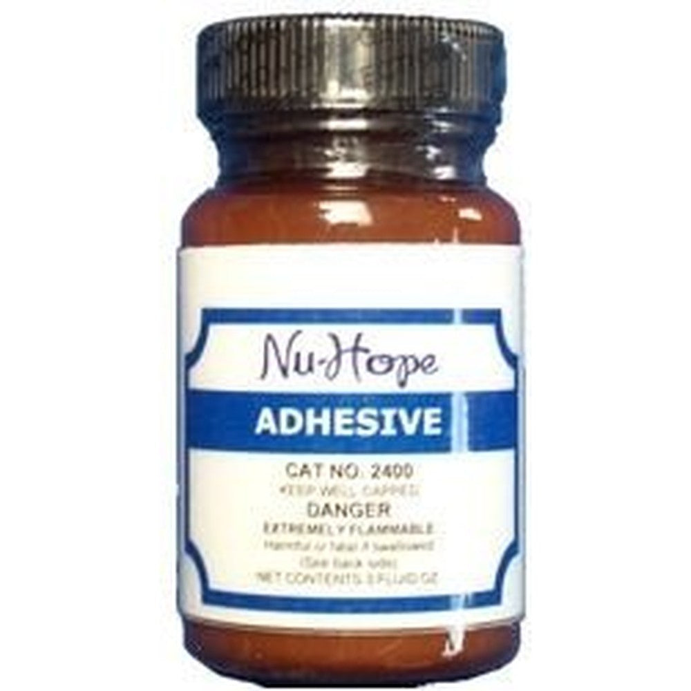 Nu-Hope Labs Liquid Waterproof Ostomy Adhesive Cement 3 Ounce bottle with applicator brush front view.