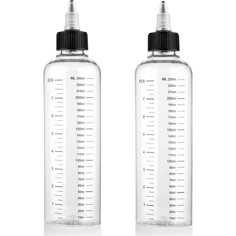 Comnico hair applicator bottle front view showing the transparent plastic body and black twist top cap.