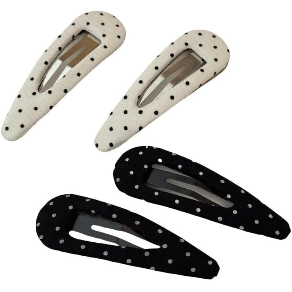 Generic polka dot snap hair clips front view showing classic black and white fabric patterns.