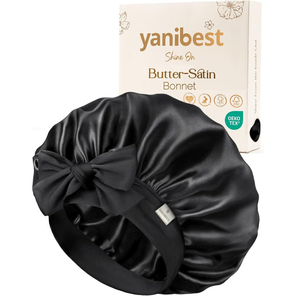 Yanibest adjustable satin bonnet front view in black on a model showing hair protection.
