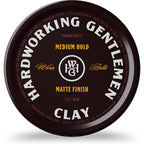 Hardworking Gentlemen medium hold hair clay front view container on plain background