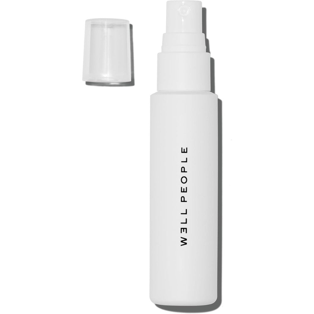 Well People Dew Your Makeup Mist front view of the white bottle on a clean background.