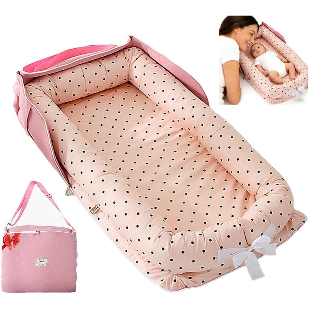 Loevin portable baby lounger front view with pink polka dots and travel bag