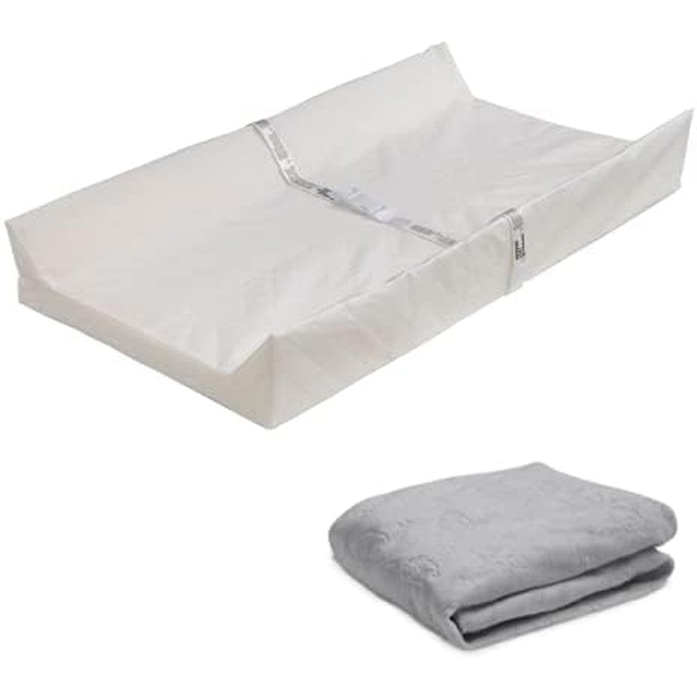 Delta Children Contoured Changing Pad front view with plush grey cover on a nursery table.