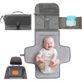 Kopi Baby Portable Diaper Changing Pad in classic grey showing front folded view as a travel clutch