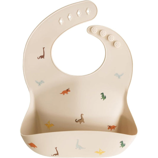 Mushie Silicone Baby Bib Dinosaurs front view waterproof feeding accessory