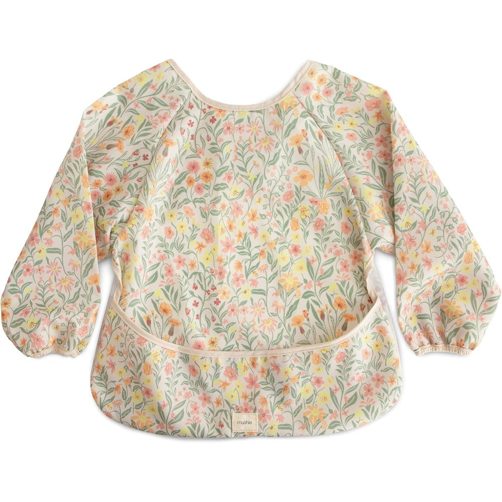 Mushie long sleeve baby bib front view in pastel blooms floral design