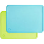 Munchkin Spotless Silicone Placemats front view showing blue and green two pack set for toddler dining.
