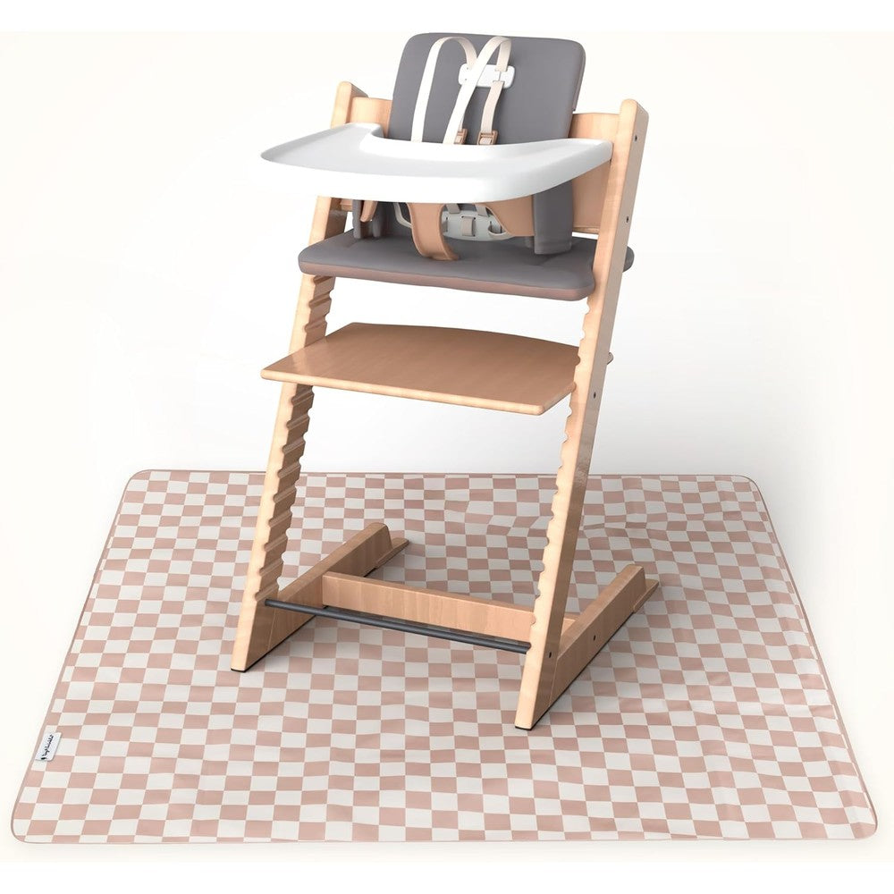 Tiny Twinkle splat mat beige checkers front view spread out under a baby high chair on a wooden floor
