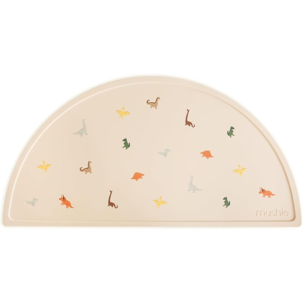 Mushie silicone placemat for kids front view showing dinosaur pattern on table mat