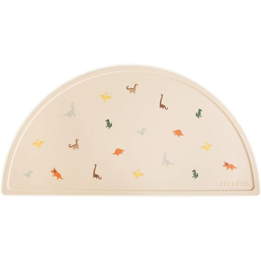 Mushie silicone placemat for kids front view showing dinosaur pattern on table mat
