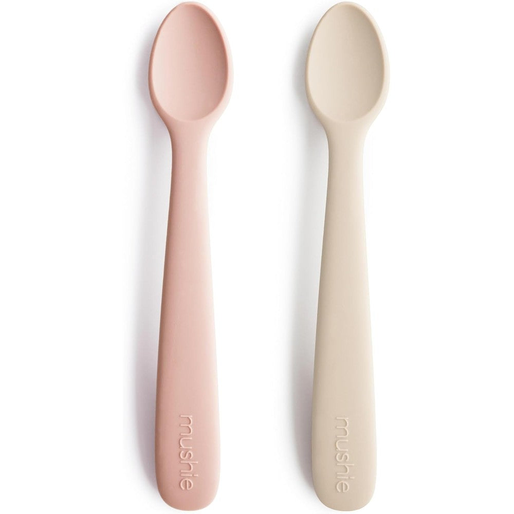 Mushie Silicone Baby Feeding Spoons front view showing Blush and Shifting Sand colors.