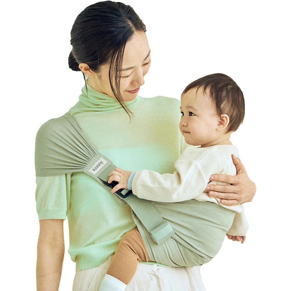 Konny baby carrier hip seat green tea front view ergonomic design