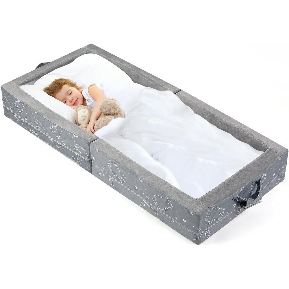 U-Moving portable toddler travel bed front view showing grey soft foam mattress and safety rails