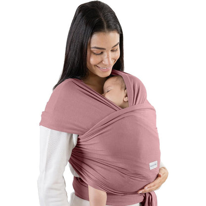 Comfy Cubs Baby Wrap Carrier in mauve front view on a caregiver carrying a newborn baby.