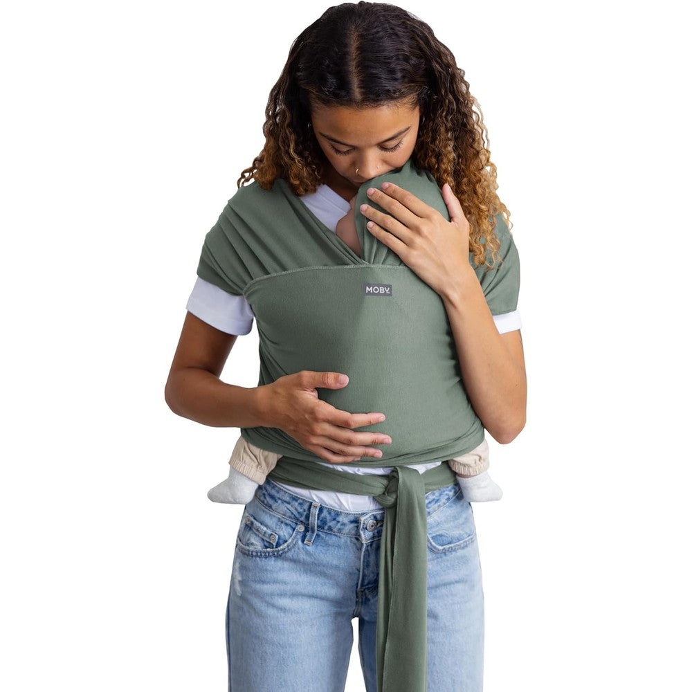 Moby Basics Baby Wrap Carrier in Spring Basil front view on a caregiver.