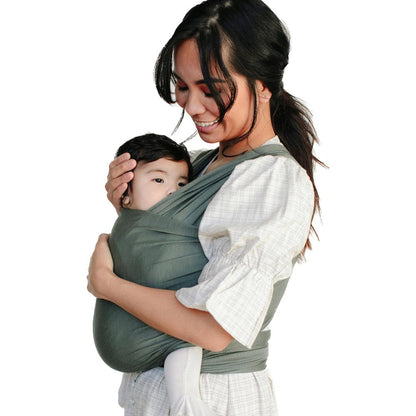 Solly Baby Wrap in Basil front view worn by a mother carrying her newborn infant.