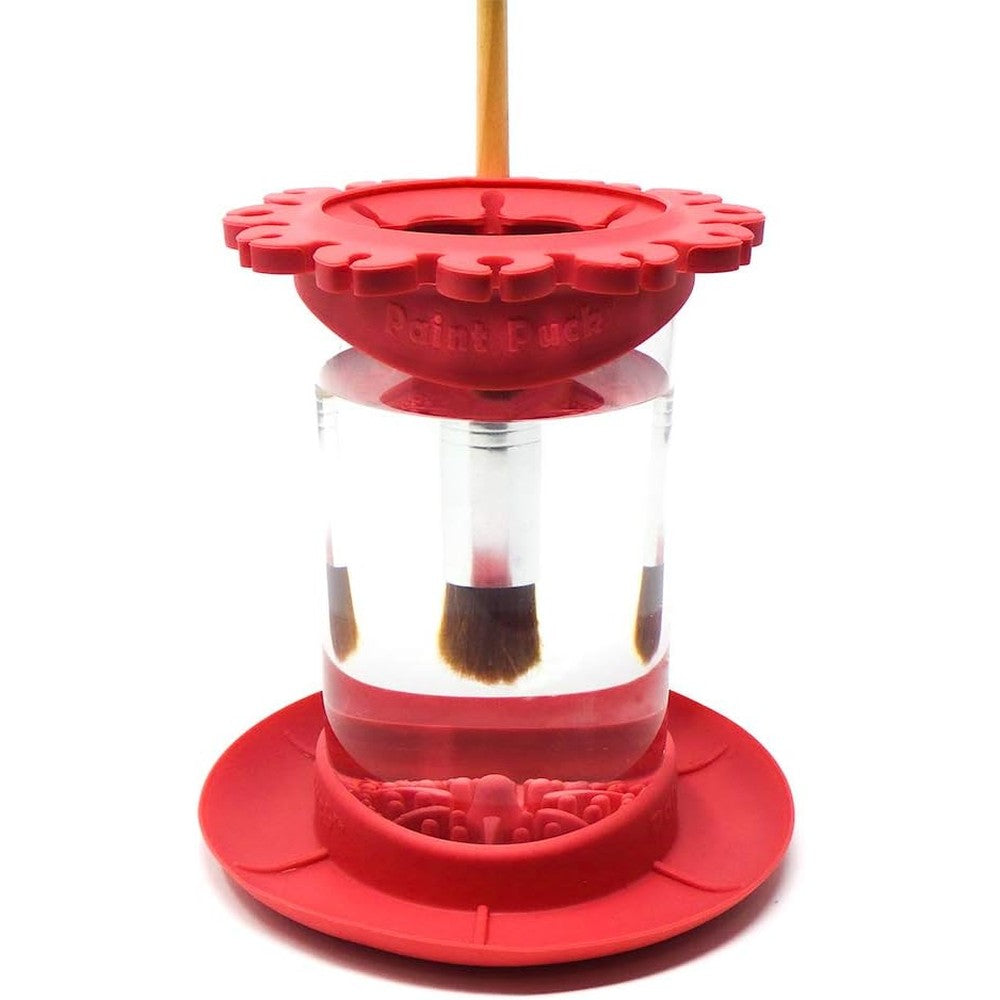 Paint Puck Ultimate Rinse Cup front view showcasing the red silicone lid and clear glass jar studio setup