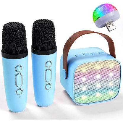 KidsFaves portable mini karaoke machine front view blue speaker with two wireless microphones and glowing LED lights.