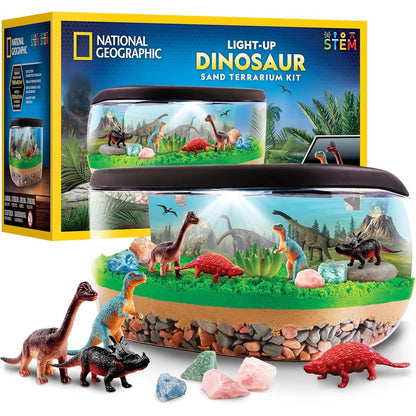 National Geographic Light Up Dinosaur Terrarium Kit front view showcasing the illuminated prehistoric habitat with sand and dinosaur figures.