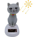 SquarezhenBo gray solar powered dancing cat doll figure front view on a sunny dashboard