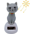 SquarezhenBo gray solar powered dancing cat doll figure front view on a sunny dashboard