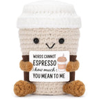 A AIFAMY Funny Positive Coffee Crochet Doll front view holding an encouragement message card on an office desk.