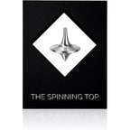 BruceCharlesDesigns Stainless Steel Spinning Top front view on desk