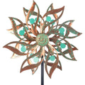 Viveta metal wind spinner front view displaying the vintage copper floral blades and green bead accents in a garden.