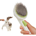 VIOJOJO self cleaning pet grooming brush front view showing green body and rounded massage pins.